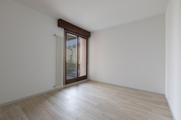 Large empty room with white walls. Parquet