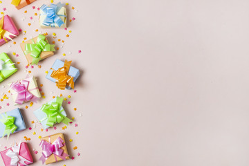 Top view colorful gifts on table with pink background