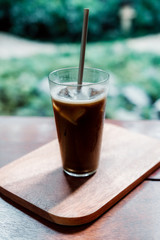 Iced Hojicha tea on woonden table.