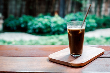 Iced Hojicha tea on woonden table.