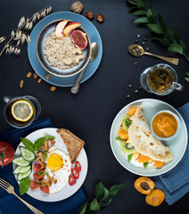 Flat lay. Menu. Three breakfasts, oatmeal, fried eggs, pancakes, tea, tea background.