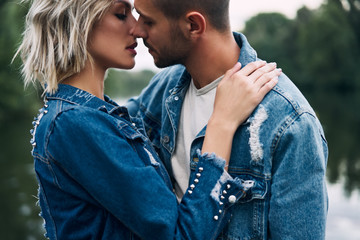 Young loving couple kissing and enjoying the company of each other outdoors