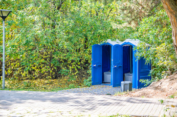blue public toilets in the park. open