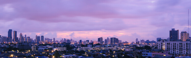 Fototapeta premium Panoramic cityscape skyline at twilight with modern skyscrapers under purple and pink sky background