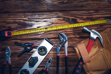 Close up tools on a wooden background.