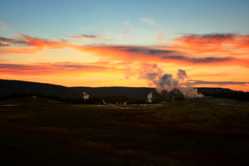 Fototapeta na wymiar erupt geysers at dusk, Yellowstone, Wyoming