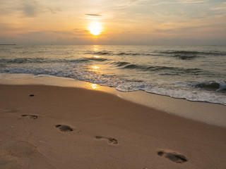 Footprint on sunrise beach