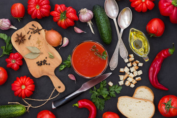 Set of vegetables and spices for making gazpacho tomato soup. Black background.
