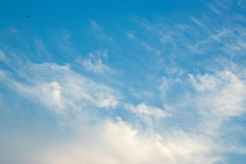 Abstract blurred background Blue sky with white clouds in sunlight.