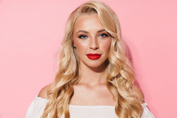 Image closeup of adorable seductive woman wearing red lipstick looking and posing at camera