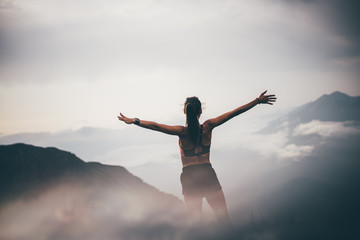 Running woman on top of mountain happy and celebrating success. Woman n the nature mountain...