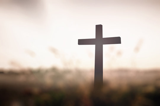 Cross on sunset background