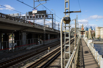 Fototapeta premium railroad tracks passing through the metallic structure of the bridge and highway in Moscow Russia