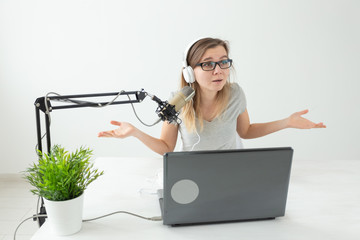 Radio host, streamer and blogger concept - Woman working as radio host at radio station sitting in...