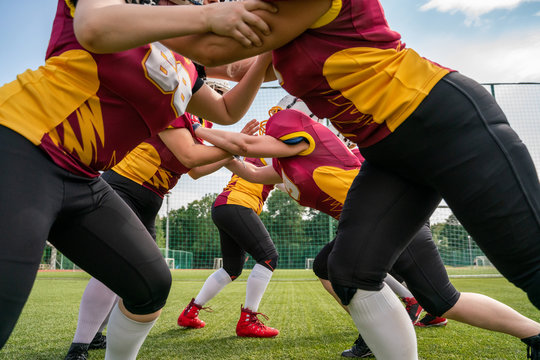Photo of athletes women playing american football on green lawn