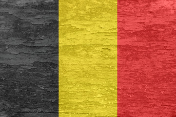 Belgium flag on an old painted wooden surface.