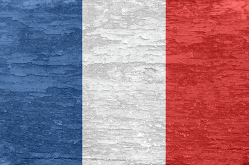 France flag on an old painted wooden surface.