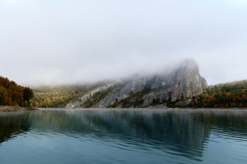 Fog on a lake in Norway in the autumn. Mist Lake mountains