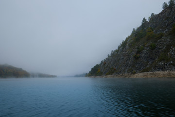 Fog on a lake in Norway in the autumn. Mist Lake mountains