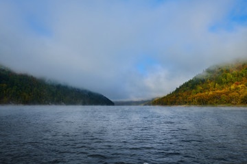 Fog on a lake in Norway in the autumn. Mist Lake mountains