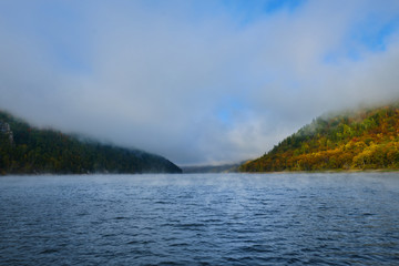 Fog on a lake in Norway in the autumn. Mist Lake mountains