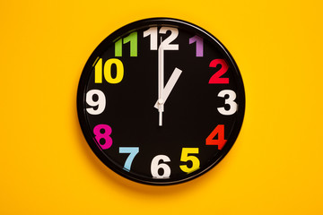 colorful wall clock show one o'clock