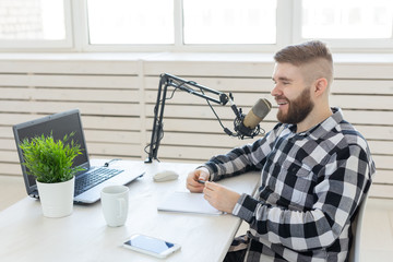 Radio host concept - Side view of handsome man working as radio host at radio station