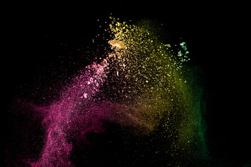 Abstract colorful dust particles textured background.Multicolored powder explosion on black background.