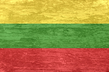 Lithuania flag on an old painted wooden surface.