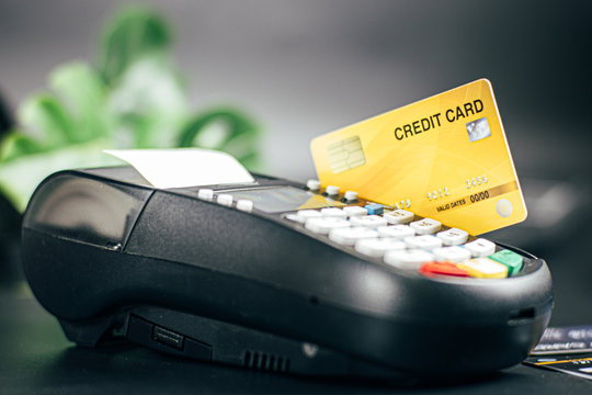 Credit card reader machine or Payment terminal with credit card on table
