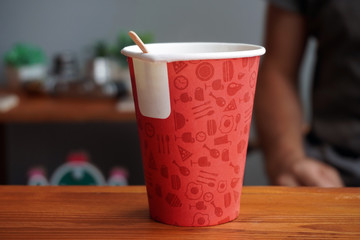 empty red cardboard cup mixer with wooden stick