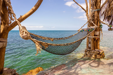 Empty hammock on beautiful tropical beach near sea water Thailand
