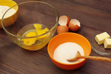 Traditional ingredients for making dough for baking on a wooden table.