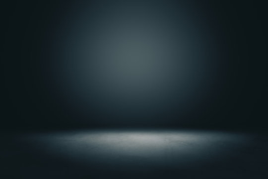 Abstract blank dark wall with copyspace and dark stage with spot light from above in empty hall.