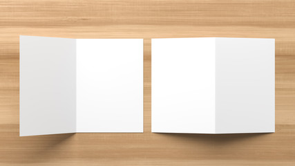 Realistic bi fold brochure or invitation mock up isolated on wooden background. 3D illustration.