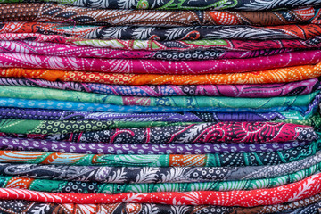 Assortment of colorful sarongs for sale in local market, Island Bali, Ubud, Indonesia. Closeup