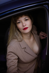 portrait of a young woman in a suit in car
