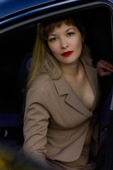 Fototapeta na wymiar portrait of a young woman in a suit in car