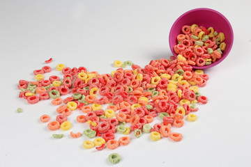 colorful cereals in the fallen bowl