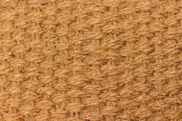 Background texture of natural material matting, cannabis hemp fiber. Material woven from natural hemp. Texture yellow brown beige