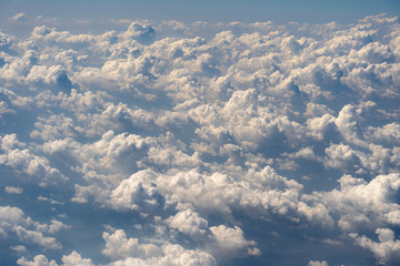 Fototapeta na wymiar White clouds and sky, a view from airplane window
