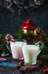Hot winter white drink with candy sticks, Christmas or New Year decorations, dark background, rustic style, copy space