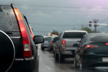 Obraz na płótnie Canvas Break of black car on asphalt roads during rainy time. Stop by traffic red light control.