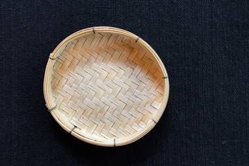 Empty wicker basket on black background