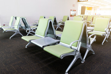 Bench in the terminal of airport. empty airport terminal waiting area with chairs.