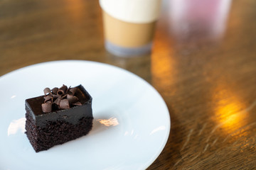Chocolate cake on wooden table at coffee shop