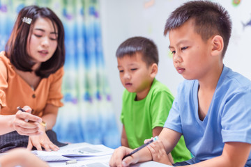 Asian elementary school boys are studying in the classroom.