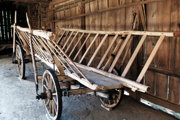 Fototapeta na wymiar old wooden peasant wagon parked in a shed