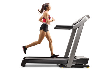 Young sporty female athlete running on a treadmill