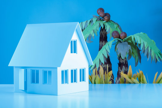 Concept - house on the beach. Concept - apartments in tropical countries. Real estate purchase on islands. House next to a palm tree. House by the sea. Cottage on the waterfront. Housing by the sea.